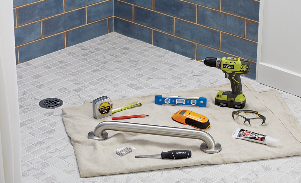 An assortment of tools needed to install a grab bar.