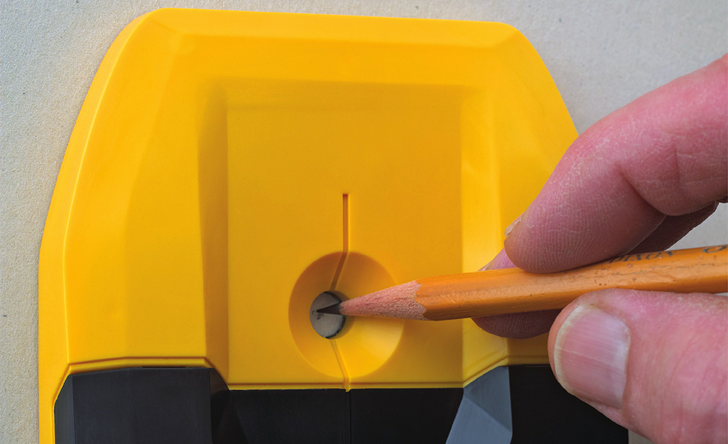 Using a pencil to mark the mounting hole Using a pencil to mark the mounting hole