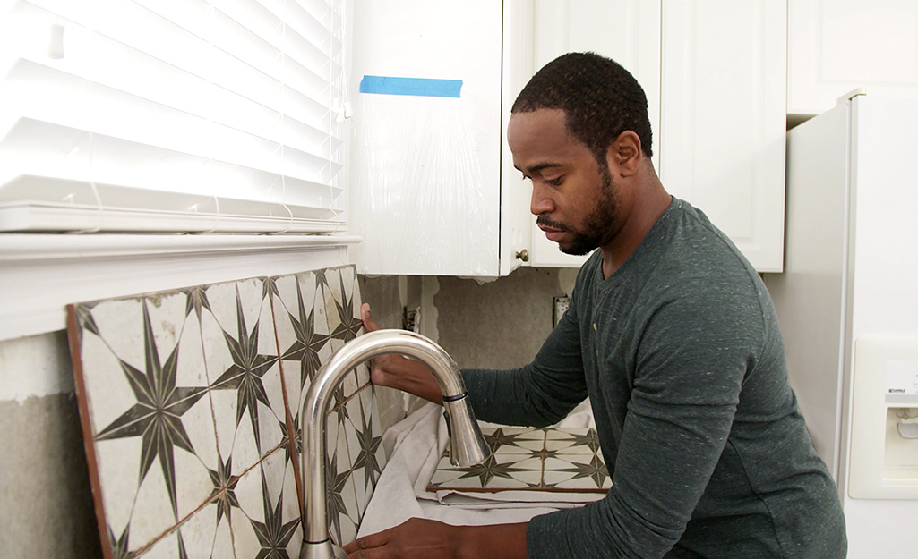 Someone doing a dry install with backsplash tile.