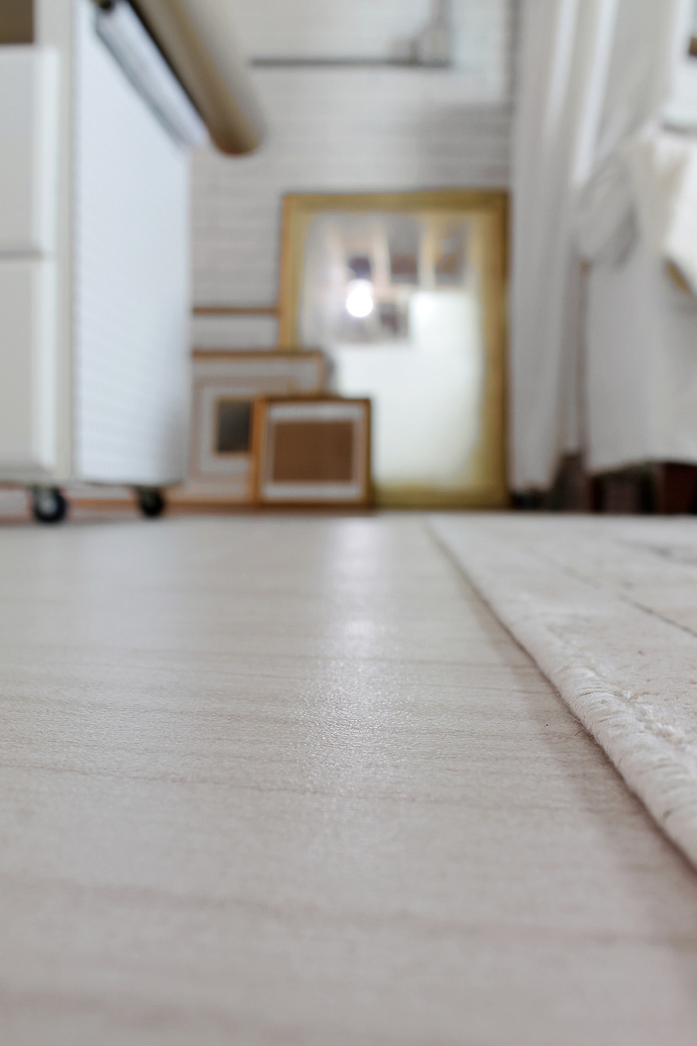 A close up of a basement floor with vinyl tile.