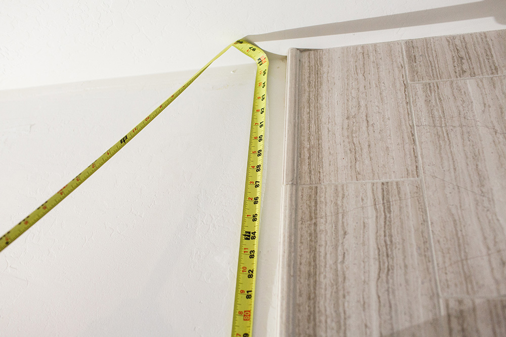 A tape measure is extended on a wall.