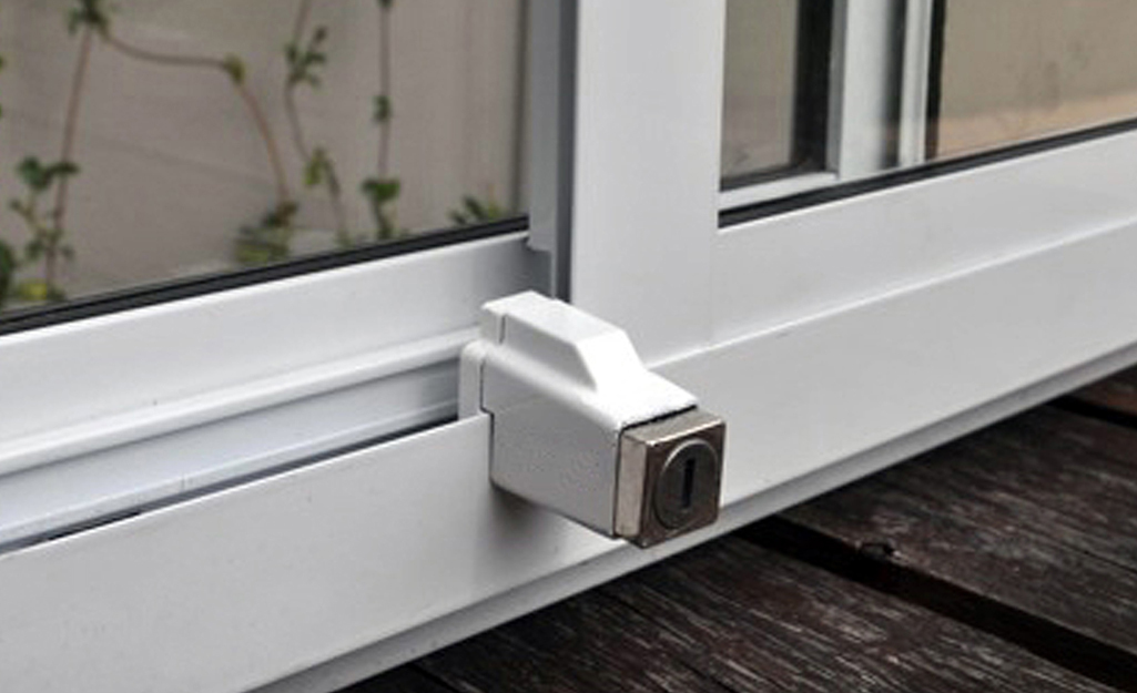 A key track stop attached to a sliding window.