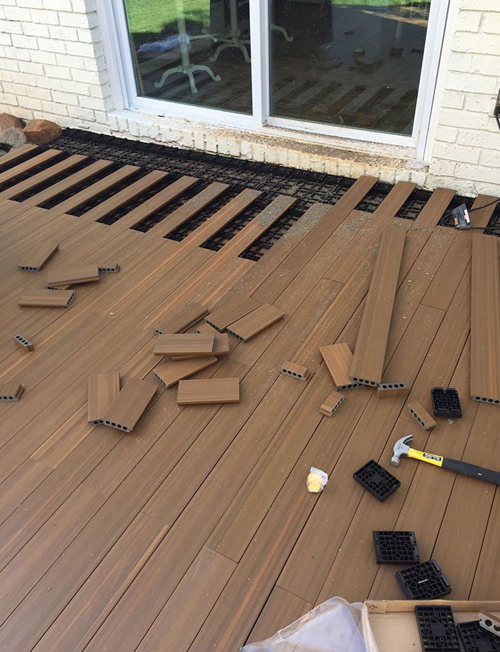 A deck with boards laid in a brick pattern.