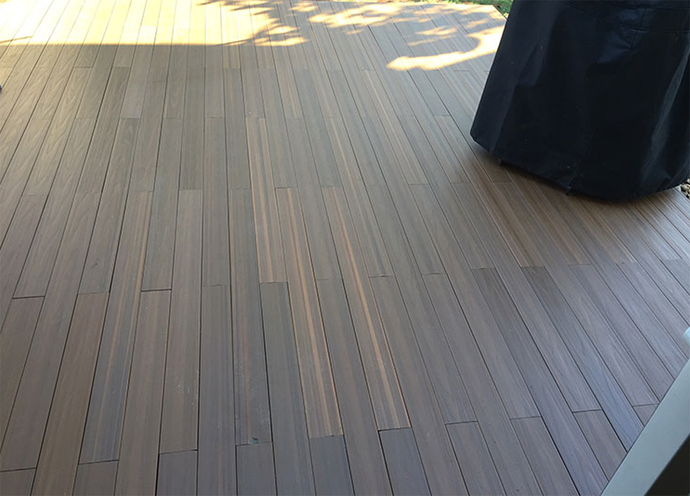 A completed deck floor on top of a concrete patio.