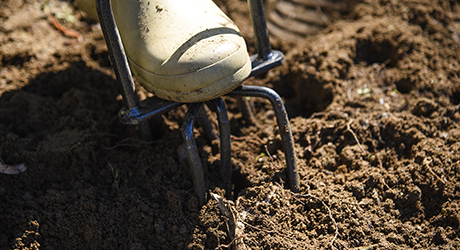 Dirt being tilled. Dirt being tilled.