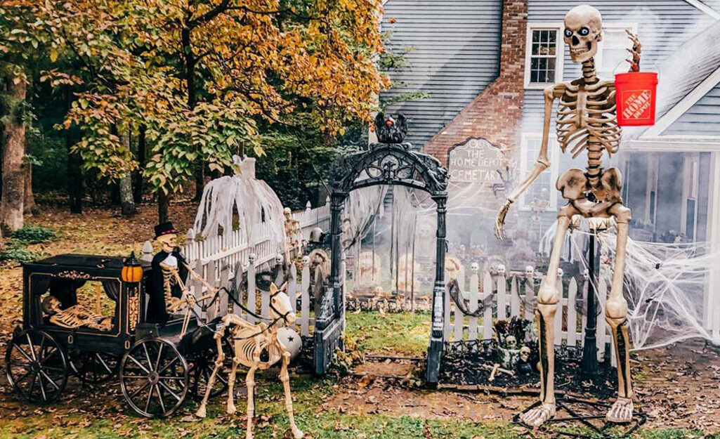 A front yard decorated with the 12-foot skeleton and other Halloween decor.