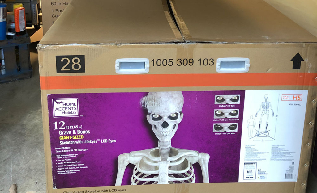 The original box that the skeleton is shipped in sits in a garage.