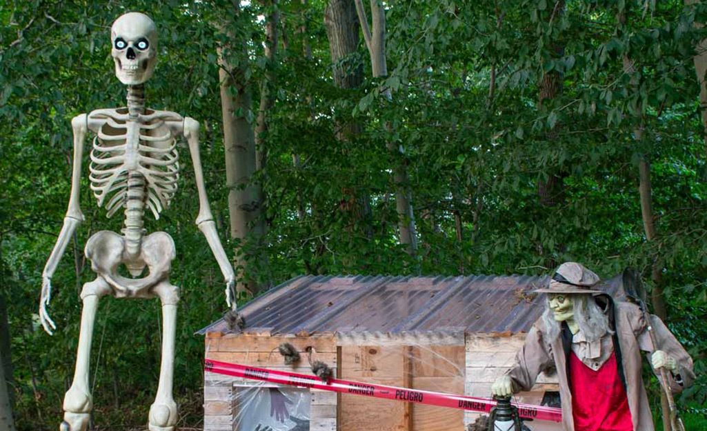 A 12-foot skeleton towers over a spooky village setup.