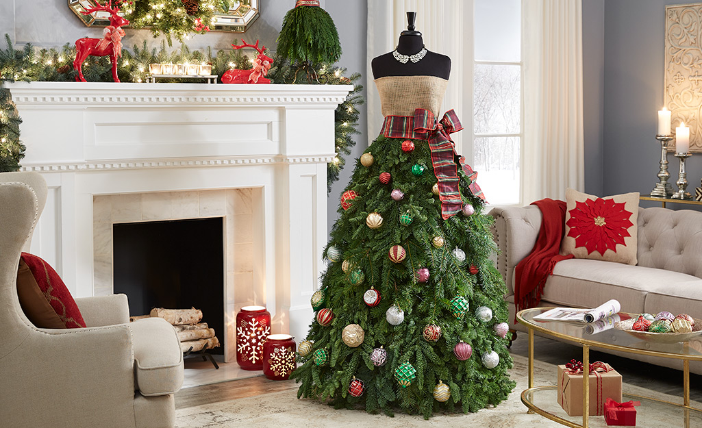 Dress form Christmas tree with ornaments by a fireplace
