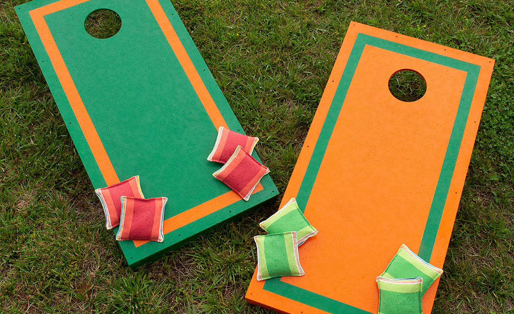 A pair of finished cornhole boards with bean bags.