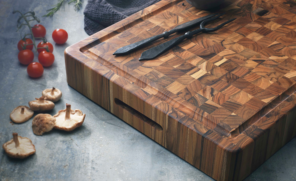 An end grain pattern wood cutting board with drip groove.