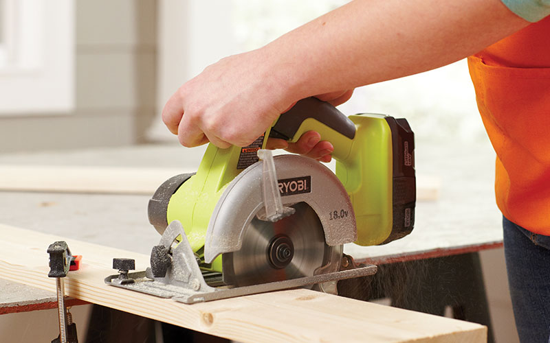 A person making cuts with a miter saw.