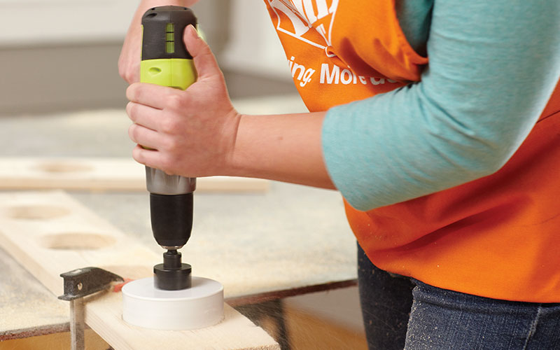 A person drilling four 4-Inch holes.