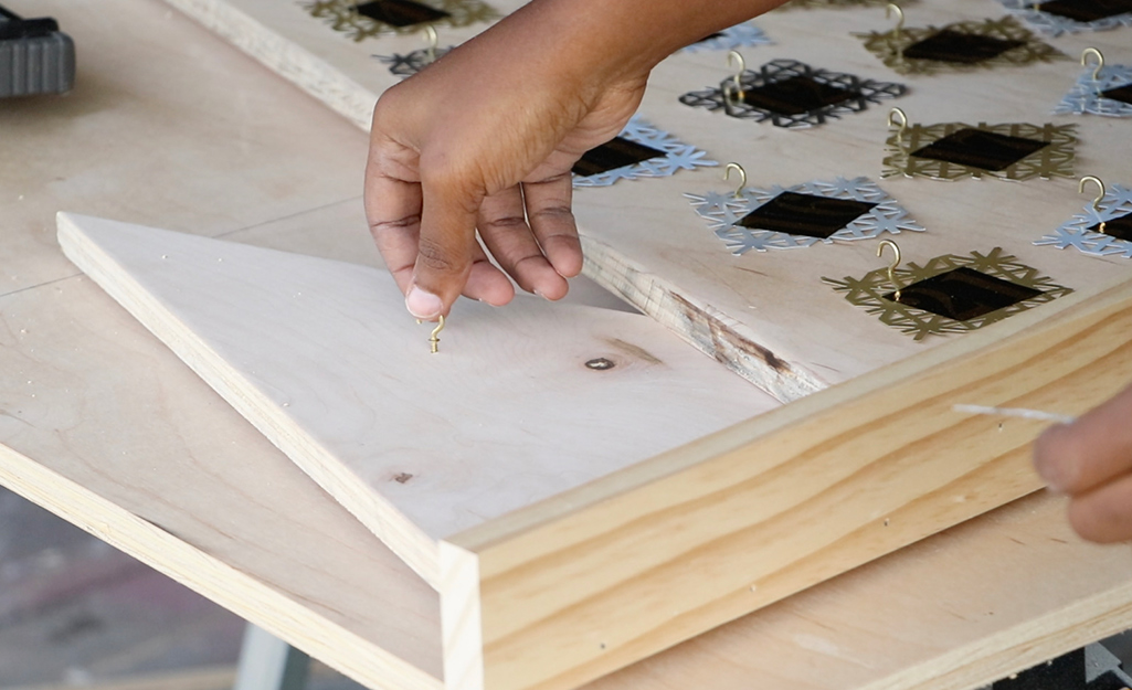 Cup hooks are added to the smaller triangle.