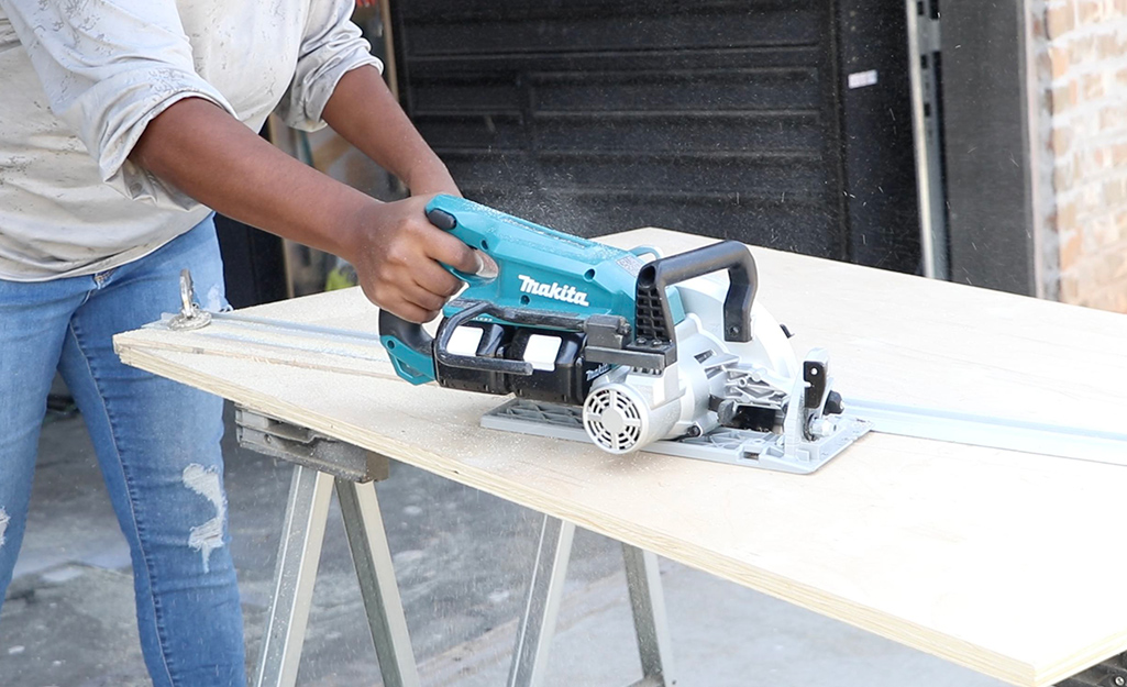 A circular saw is used to cut wood.