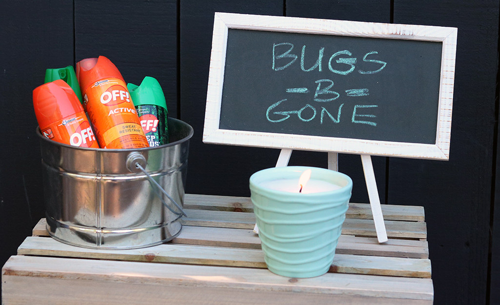 Mosquito repellant in a bucket and a citronella candle. Mosquito repellant in a bucket and a citronella candle.