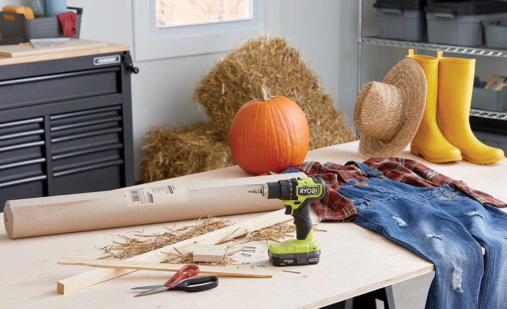 Old clothes, a pumpkin and tools gathered to make a DIY scarecrow.