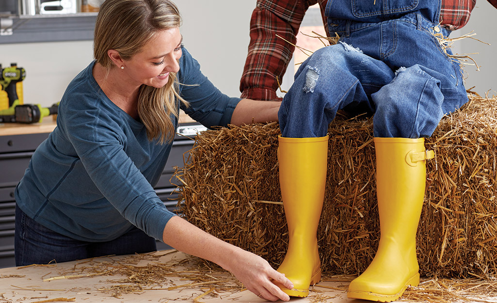 Yellow garden boots are used as the scarecrow's feet. 