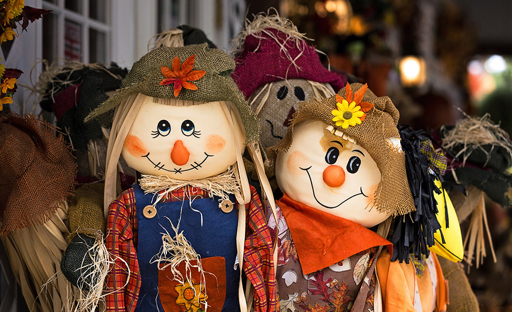 A boy and girl scarecrow smiling.