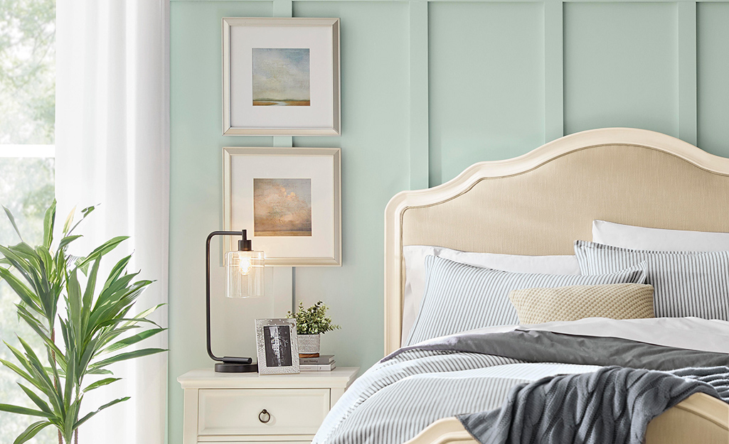 Beige bedroom furniture with pale green painted slatted walls Beige bedroom furniture with pale green painted slatted walls
