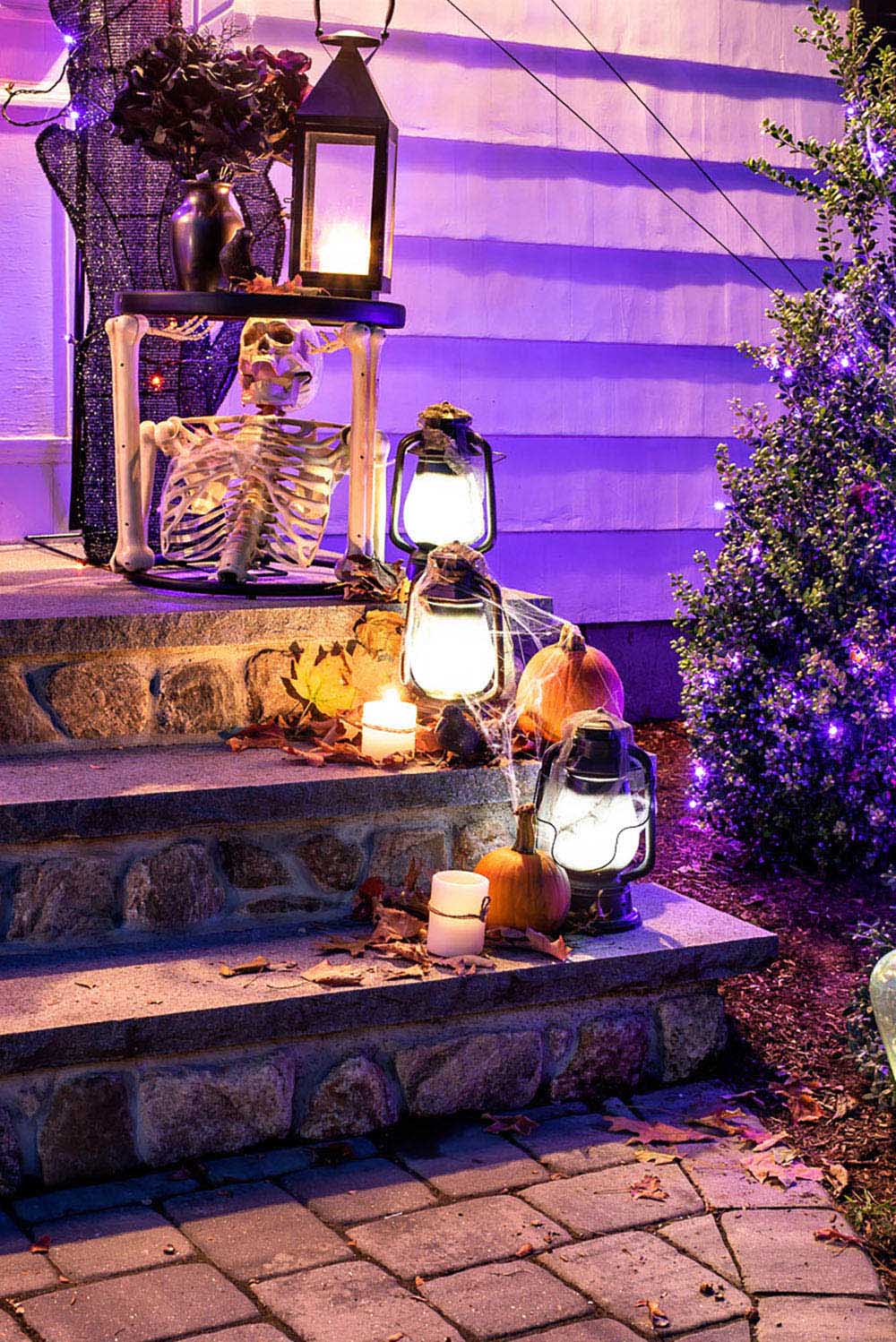 A night view of the lanterns and pumpkins on the front steps