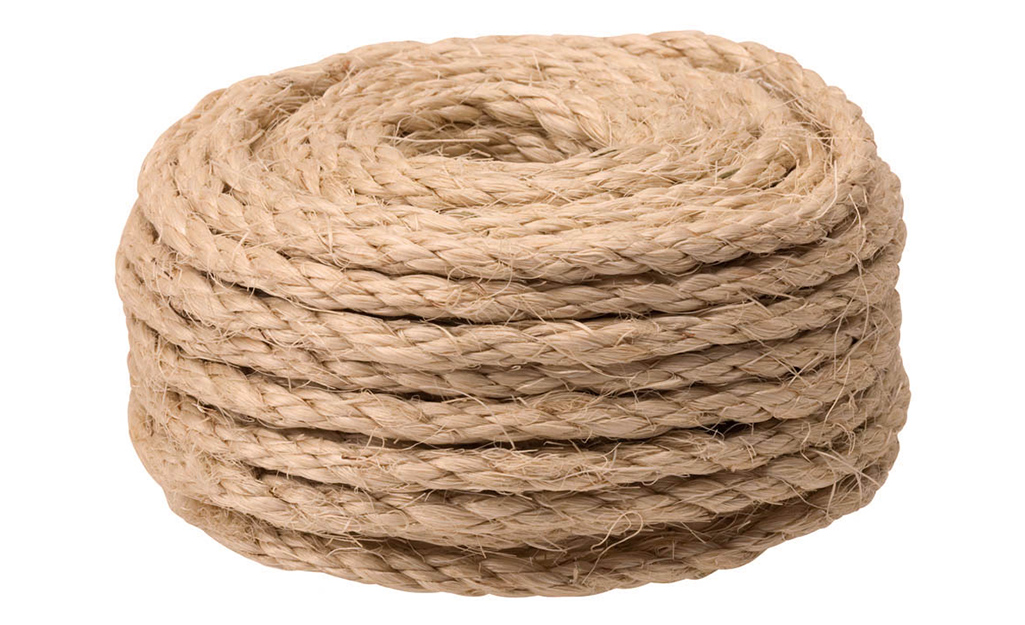 A coil of rope to be used to make a tree swing. A coil of rope to be used to make a tree swing.