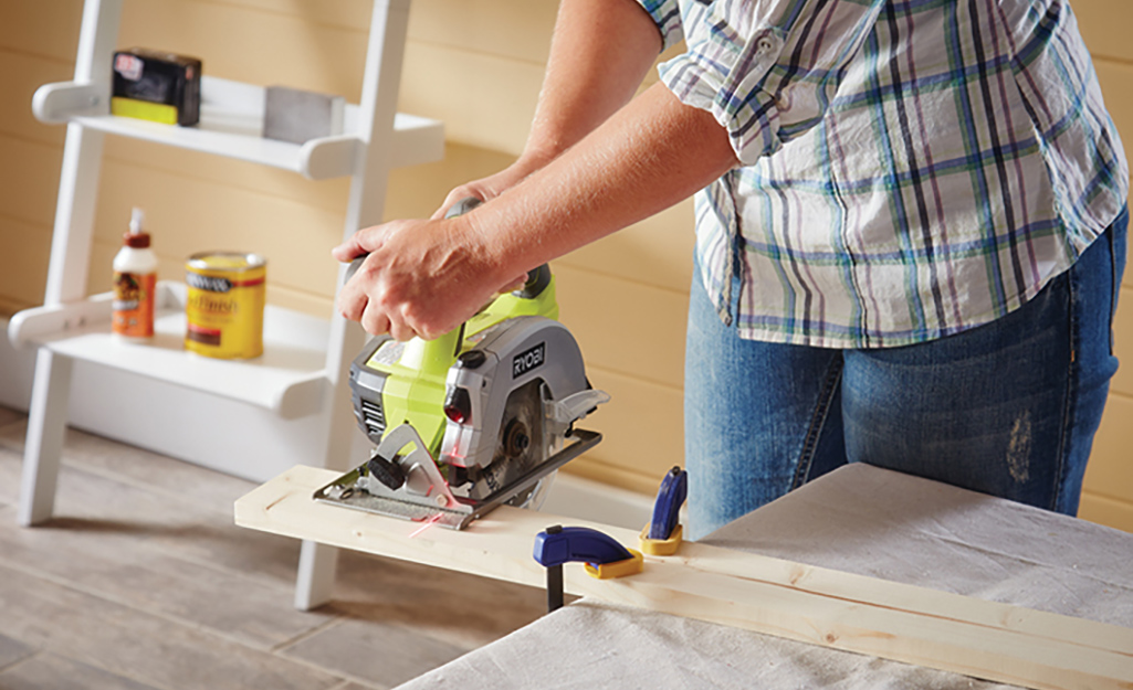 A person cuts wood pieces using a table saw.