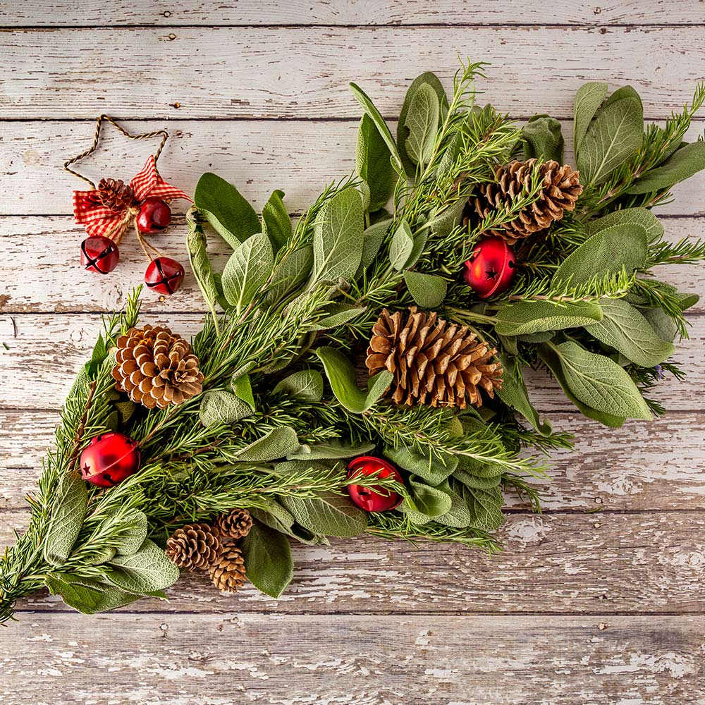 An herb centerpiece laying on a wooden surface.