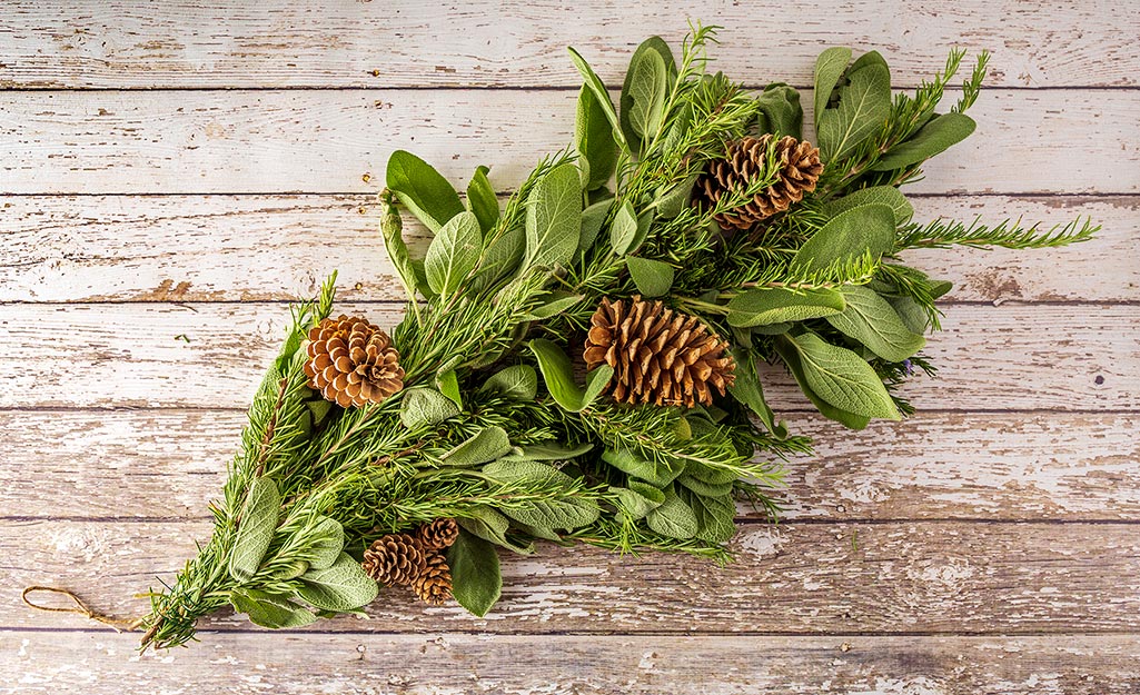 Herb bundled decorated with pinecones.