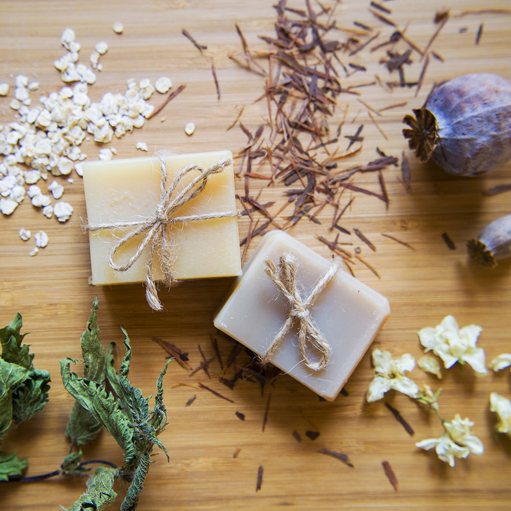 Homemade soap on a table with dried botanicals. Homemade soap on a table with dried botanicals.