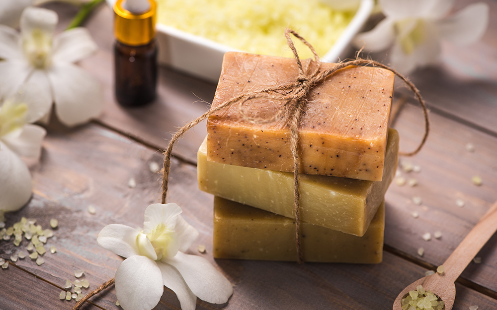 Homemade soap tied with twine on a wood table. Homemade soap tied with twine on a wood table.