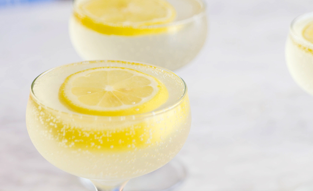 Drinks in wine glasses garnished with lemon wheels. Drinks in wine glasses garnished with lemon wheels.