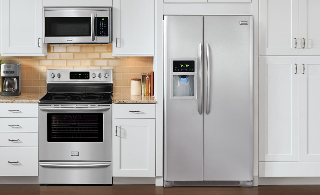A stainless steel standard refrigerator fit into built-in cabinets.