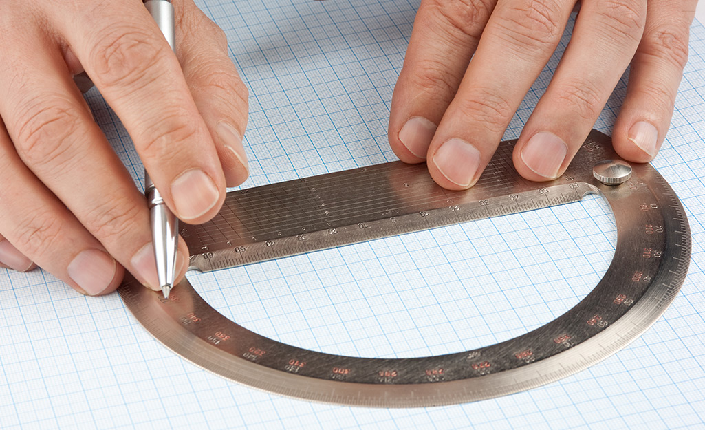 A person using a protractor. A person using a protractor.