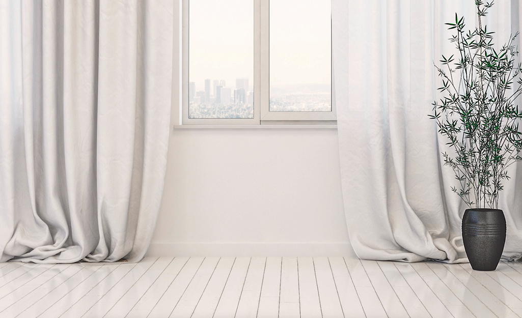 A pair of curtain panels featuring a puddle break.