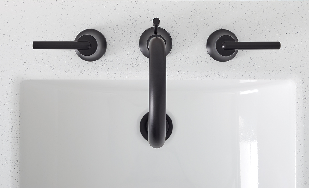 An overhead shot of a black bathroom faucet shows the spout reach.