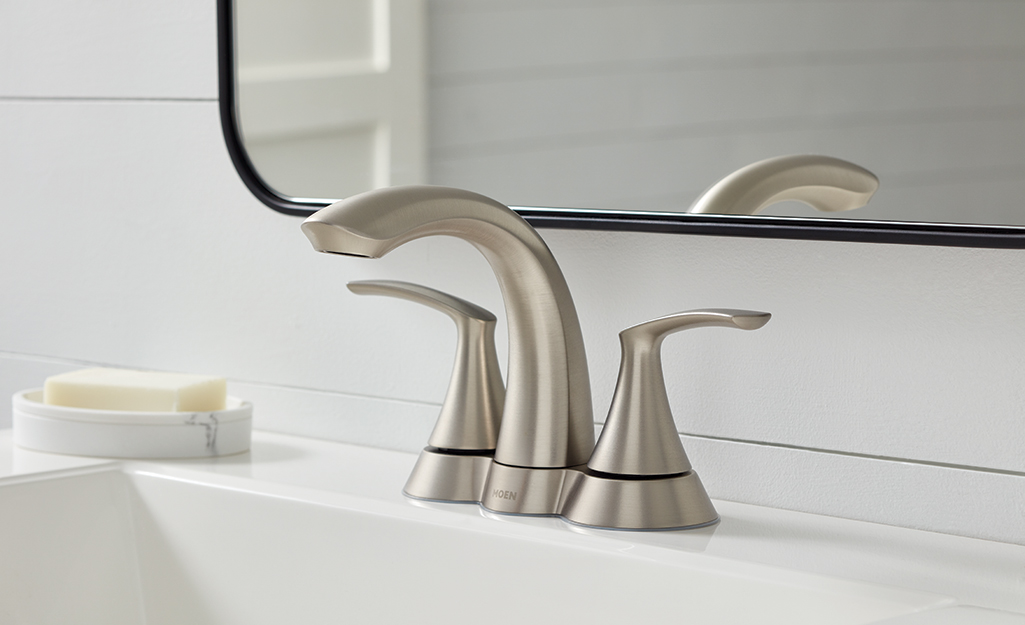 A 4-inch center set faucet is mounted on a bathroom sink.