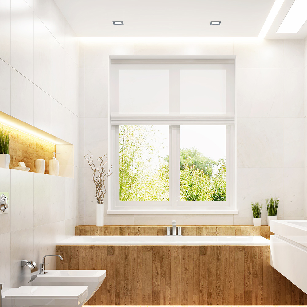 The window in a bathroom is positioned above the bathtub.