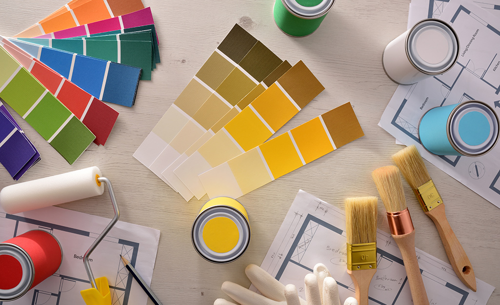 Paint samples and tools spread out on a table.