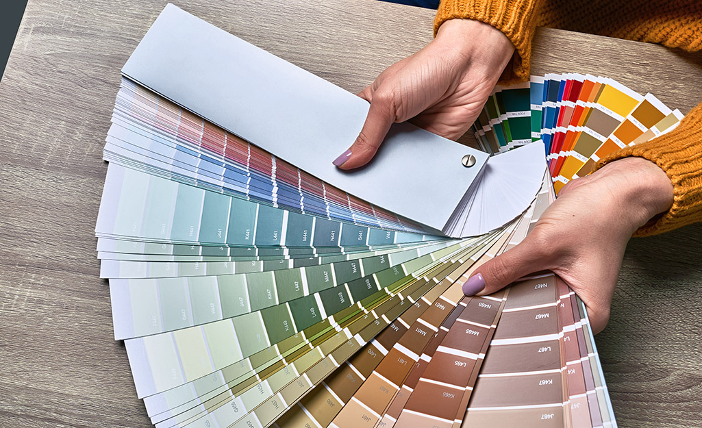 Someone holding paint color samples.