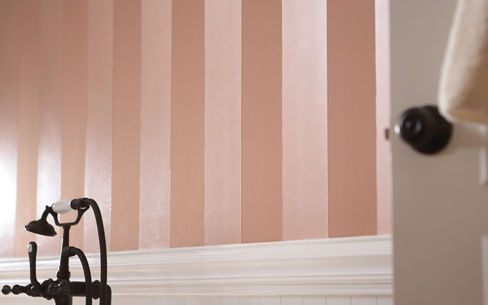 Pink and white stripes painted on a wall.