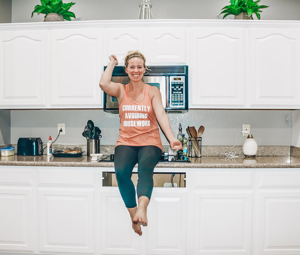 A person sitting on a kitchen counter
