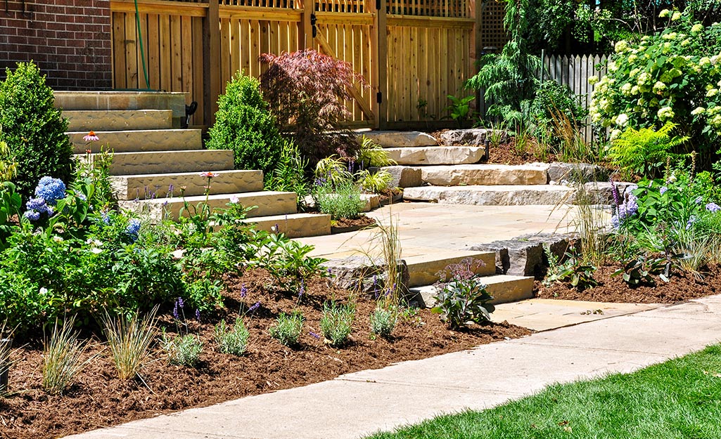 What mulch color/ variety should I replace the current mulch with to make  it look better? We have decorative stones on the border shown here and all  around our home . : r/landscaping