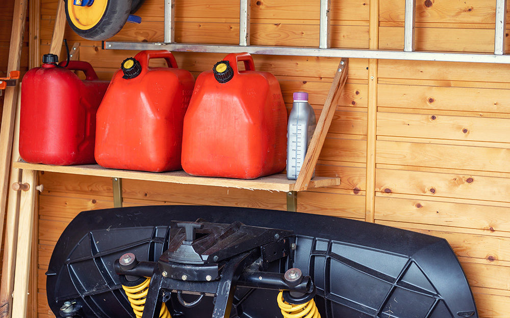 Gasoline containers are stored safely in a garage.