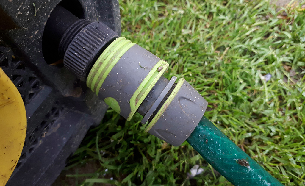 A pressure washer connected to a hose.