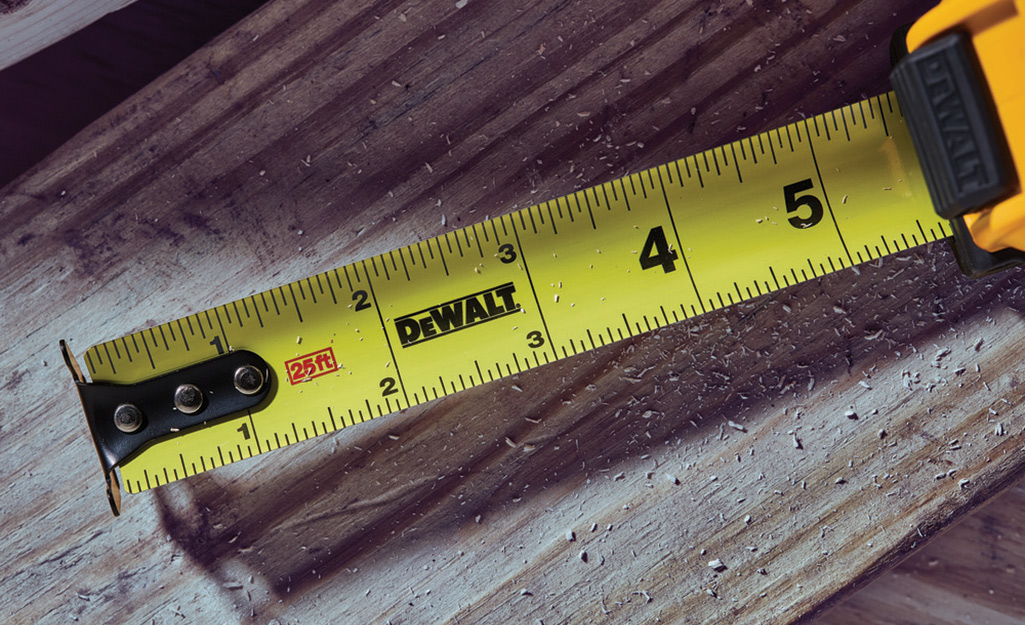 An open tape measure resting on a board.