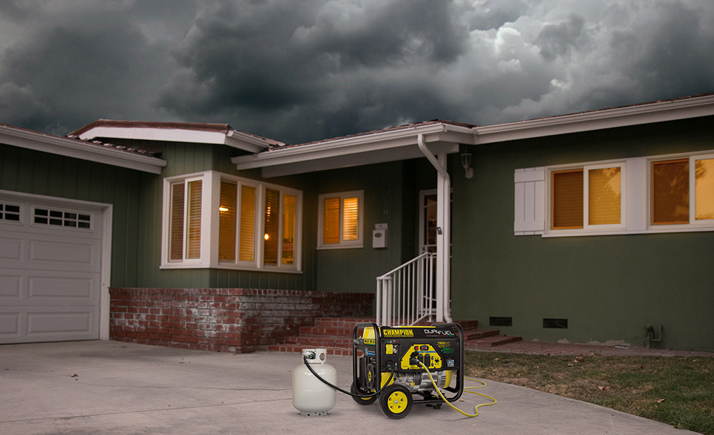 A generator sitting on a driveway. A generator sitting on a driveway.