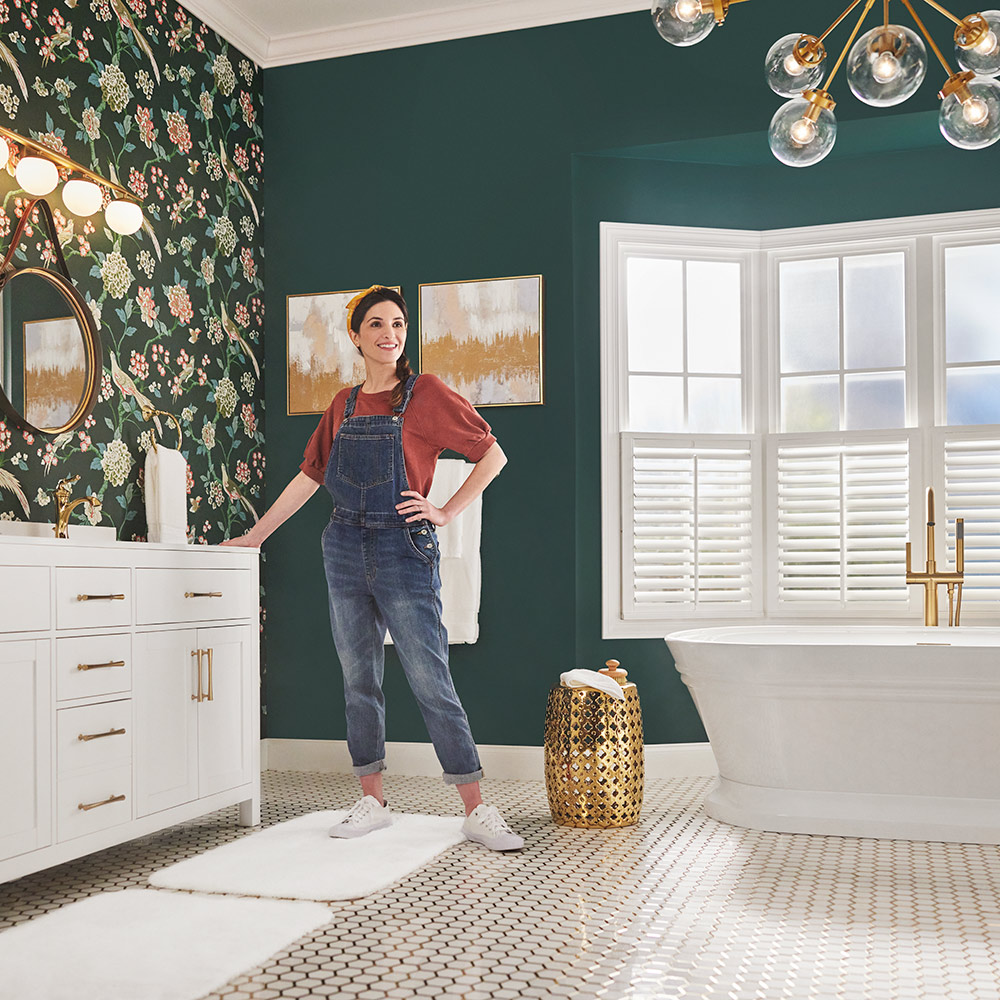 A bathroom featuring a bold botanical wallpaper and soaking tub.