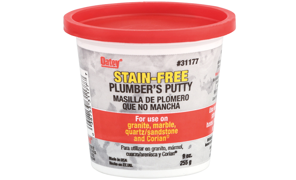A container of plumber's putty against a white background.