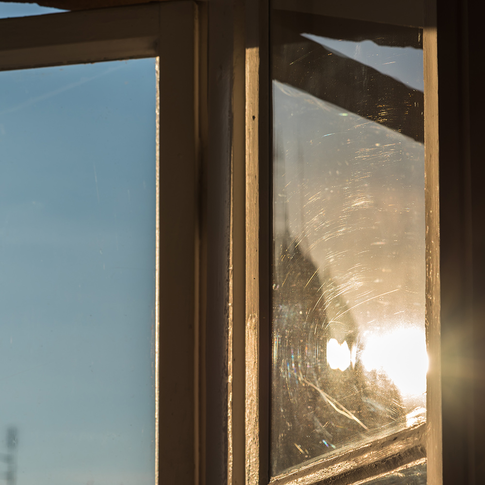 Sunlight shows scratches on window glass. Sunlight shows scratches on window glass.